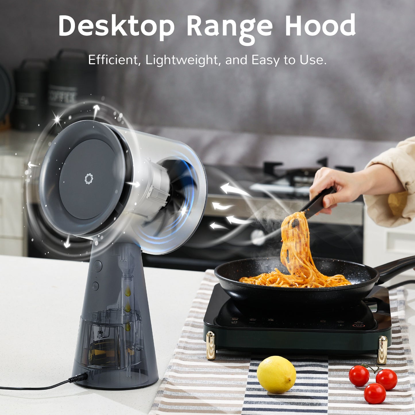 Desktop range hood with a sleek design, positioned near a cooking pan with spaghetti, demonstrating airflow and smoke extraction.