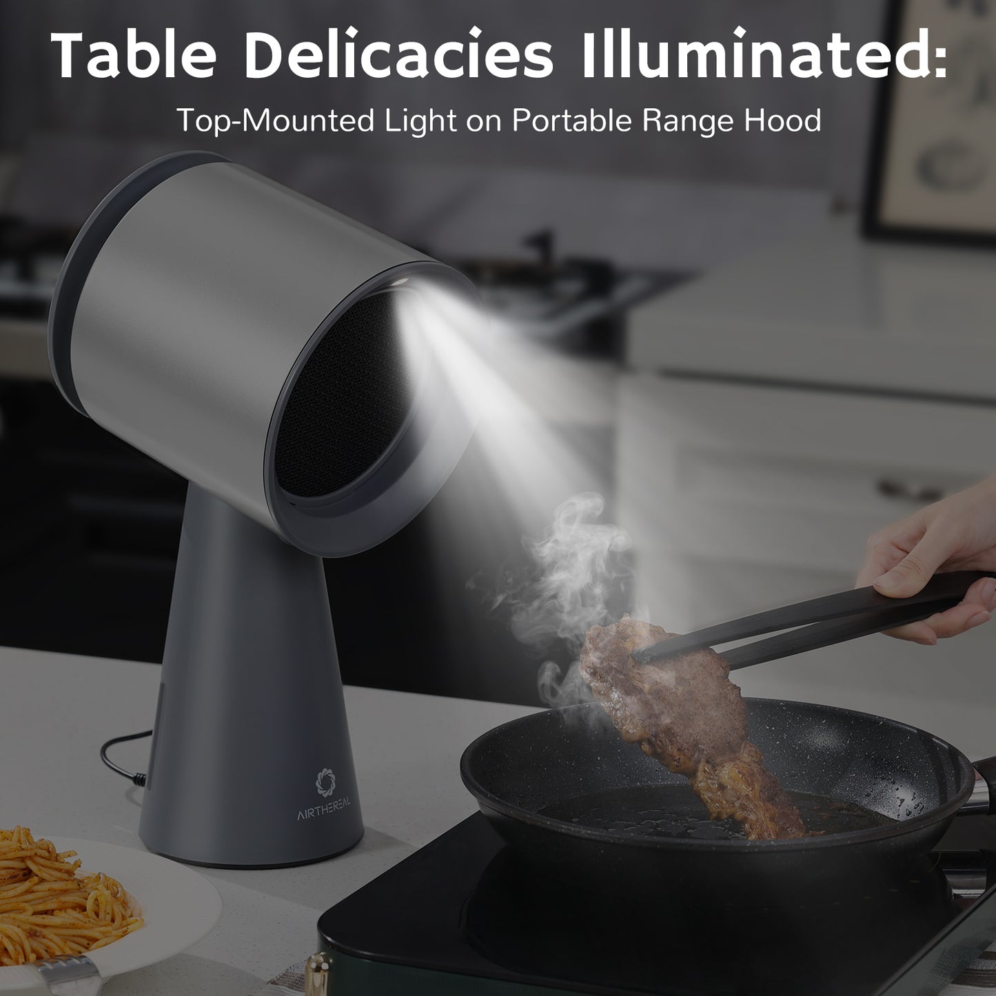 Portable range hood with a top-mounted light illuminating a frying pan with meat, showcasing smoke and cooking action in a kitchen setting.