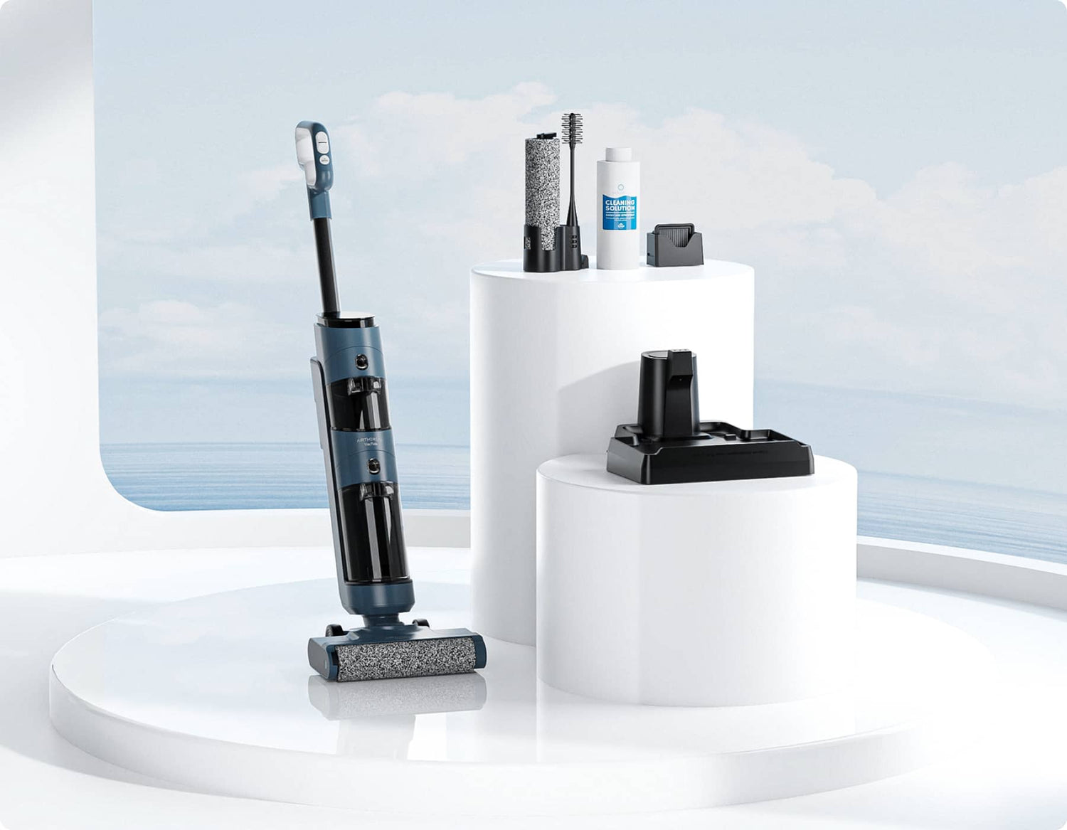 A cordless vacuum cleaner with a sleek design, positioned on a white circular display. Accessories including a cleaning solution, brush, and charging dock are arranged on adjacent stands. The background features a light blue sky and water.