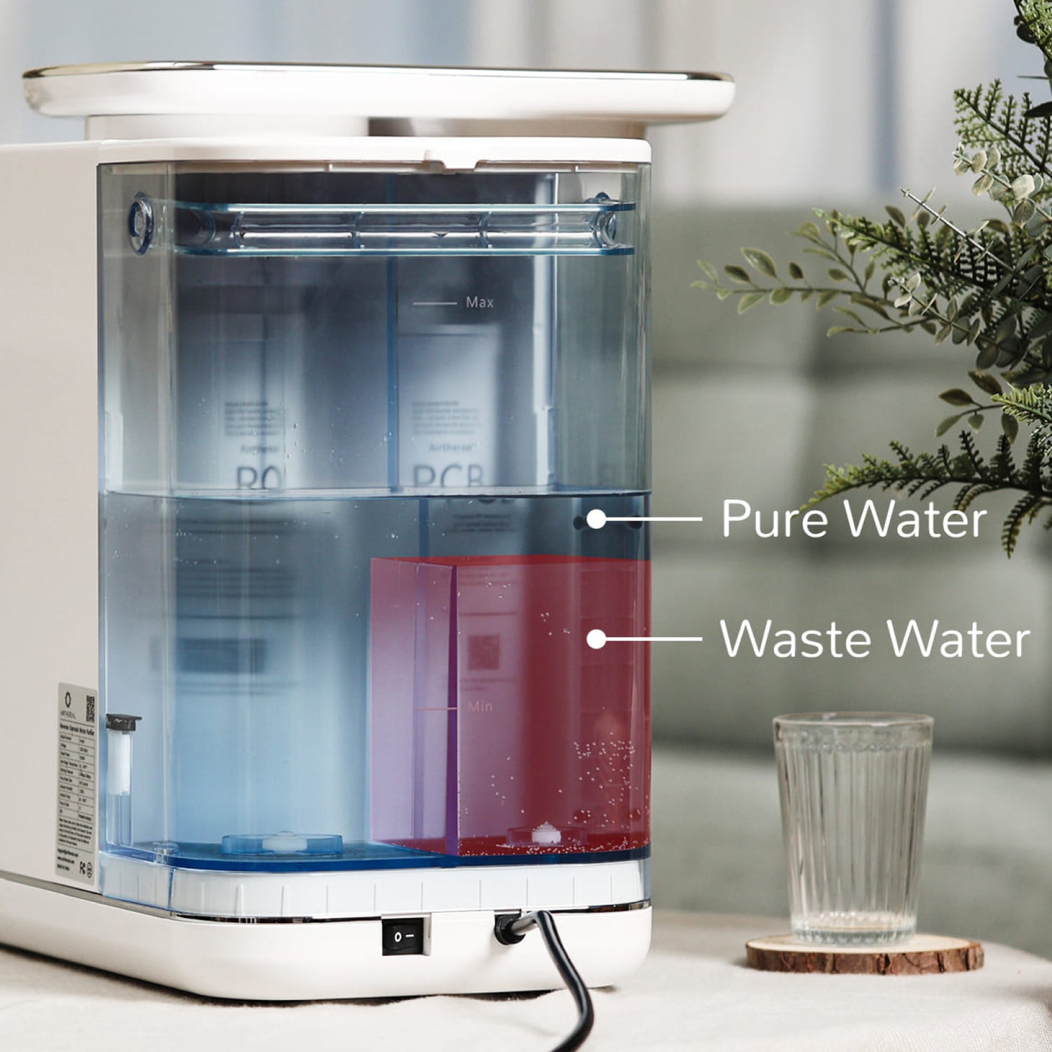 Countertop water dispenser with touch controls, dispensing water into a clear cup.