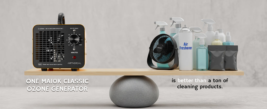 An Airthereal MA10K Classic Ozone Generator in black sits on a wooden shelf, balanced by a gray sphere. On the right side of the shelf, cleaning products including spray bottles, a small fan, and pouches are arranged.