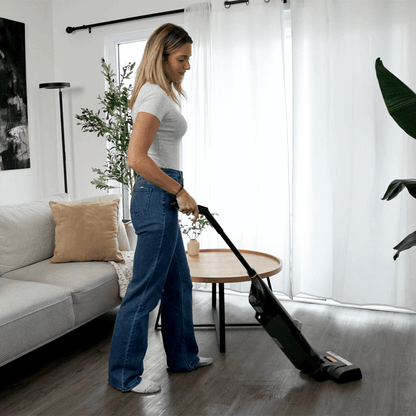 Vactide V1 upright vacuum cleaner in action, demonstrating powerful suction on a tiled floor.